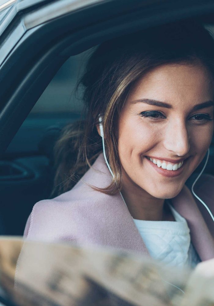 woman-with-phone-on-the-back-seat-of-a-car